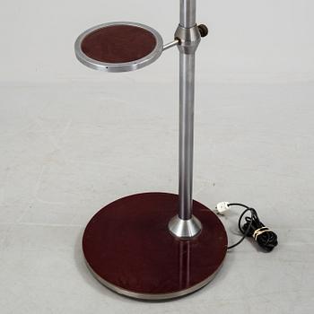 a metal floor light with table from the 1930s.