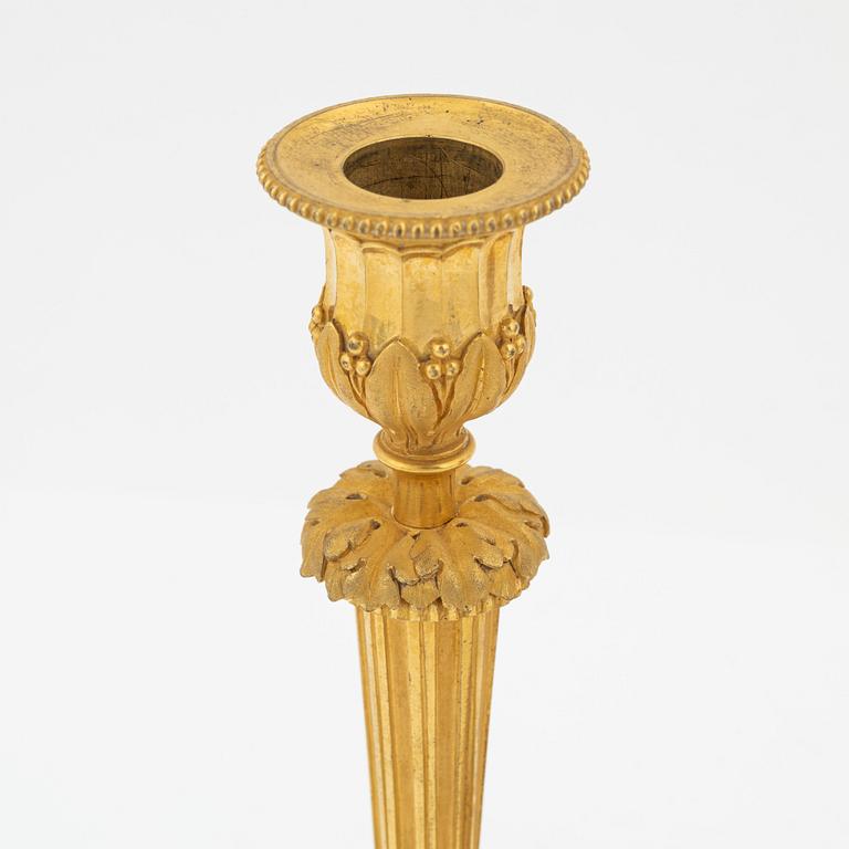 A pair of gilded bronze candelsticks, 19th Century.