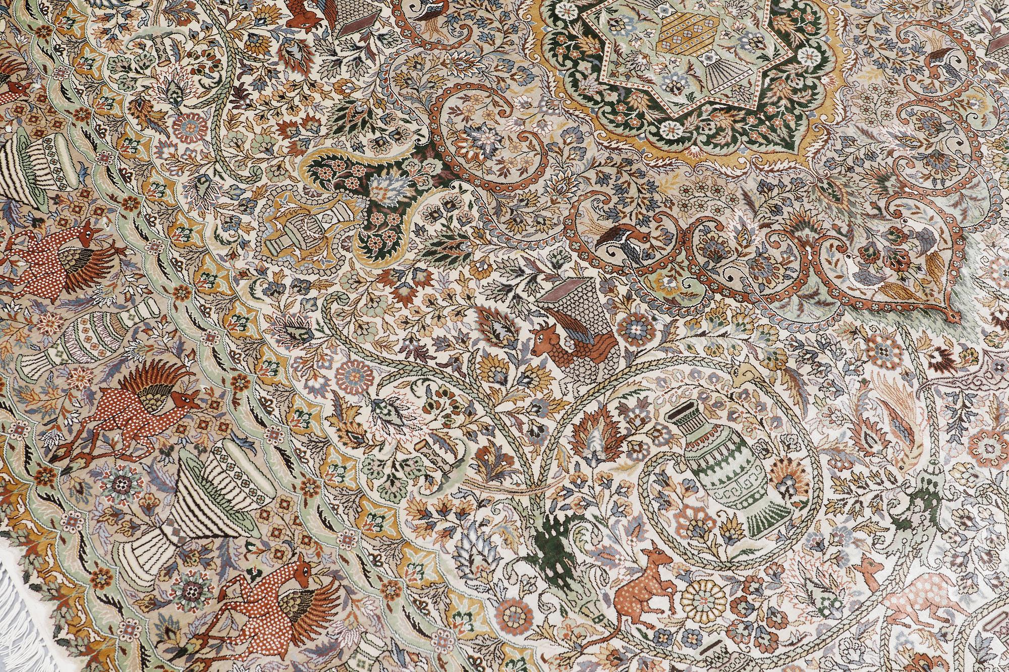 An oval pictoral silk carpet, ca 273 x 180 cm.