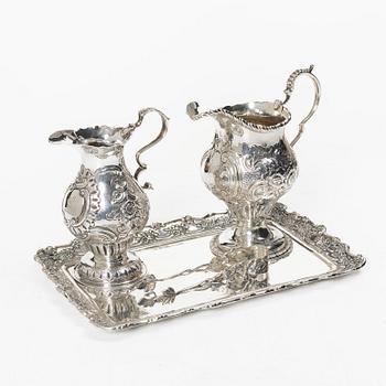 Two creamers, a tray, and a sugar tongs, silver, Rococo and Rococo style, 18th-19th century.