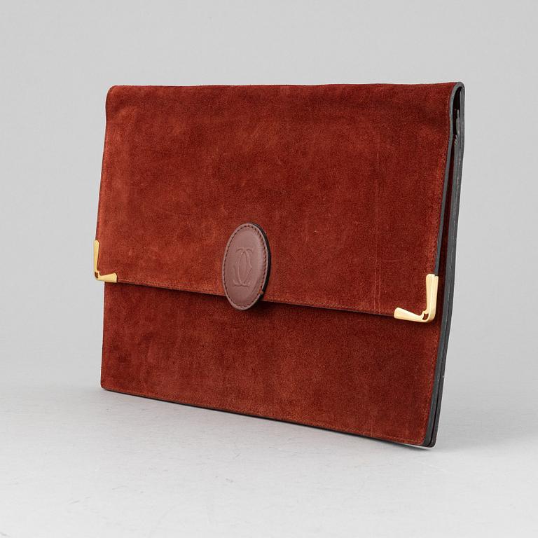 Cartier, a red suede clutch.