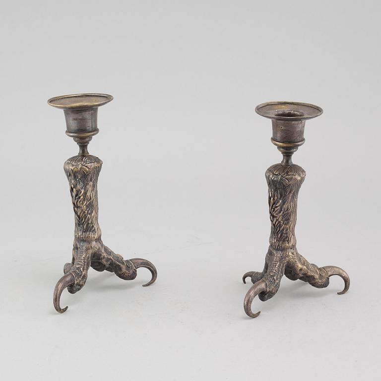 A pair of silvered metal candlesticks, around the year 1900.