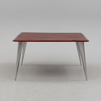 a dining table by Philippe Starck, "M Serie Lang", Driad.