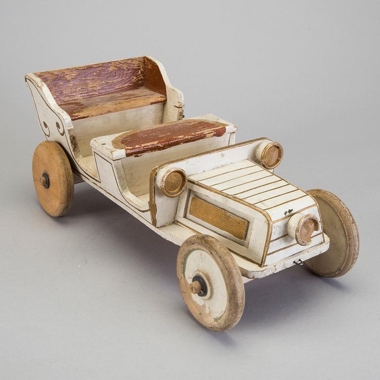 A painted wooden toy car c. 1910.