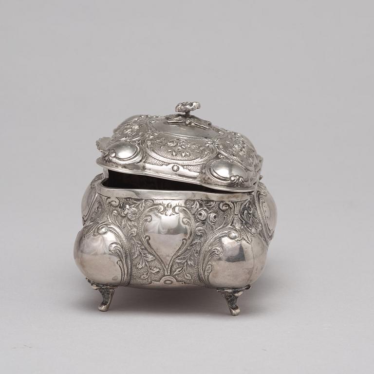 A silver sugar box.