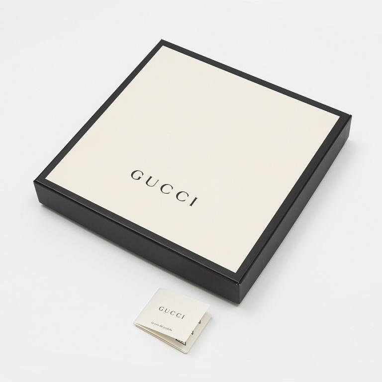 Gucci, a wool and silk mix "GG" jaquard shawl.