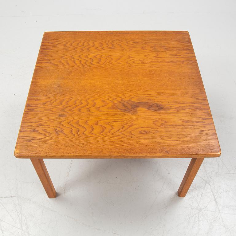An oak coffee table with a later travertine top.