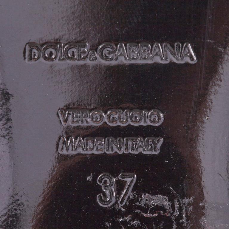 DOLCE & GABBANA, a pair of black leather sandals.