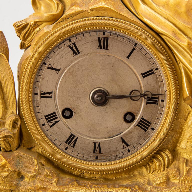 A mid 1800s bronzed late empire table clock.