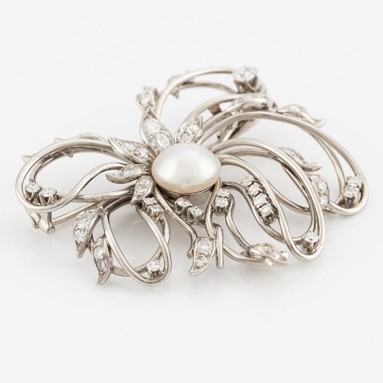 A brooch in palladium set with a half pearl and eight-cut diamonds, W.A. Bolin.