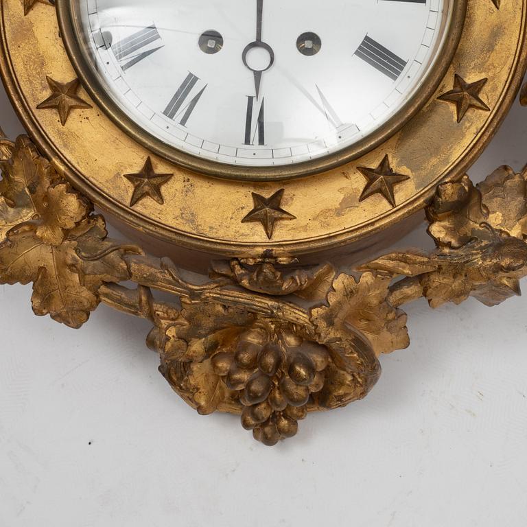 An Empire wall clock, 19th Century.