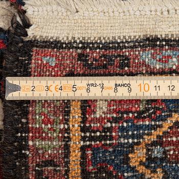An Oriental rug, approx. 200 x 105 cm.