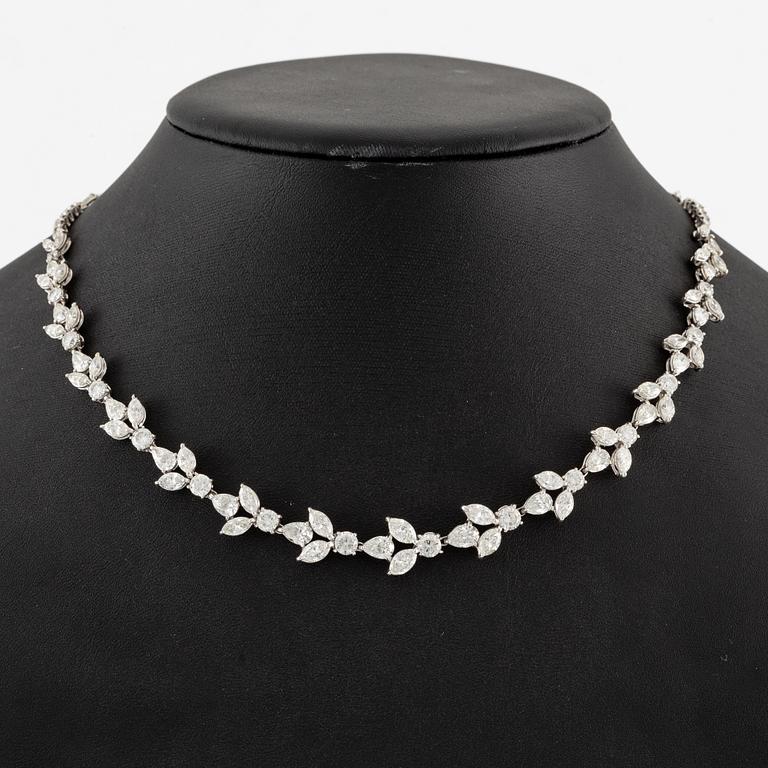 A platinum necklace set with navette-, pear- and round-brilliant-cut diamonds.
