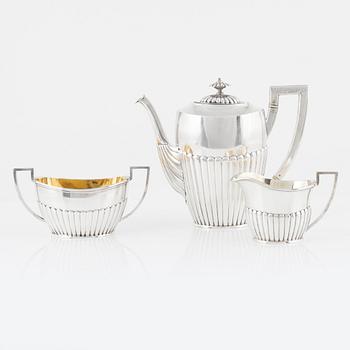 A Swedish silver coffee pot, creamer, and sugar bowl, mark of K Anderson, Stockholm 1903.