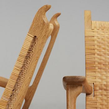 A pair of Hans J Wegner oak and rattan easy chairs 'CH-27', Carl Hansen & Son, Denmark.