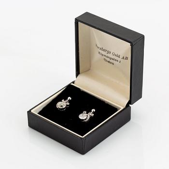 A pair of 18K white gold earrings set with old-cut diamonds.