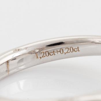An 18K white gold ring set with  a pear brilliant-cut diamond.