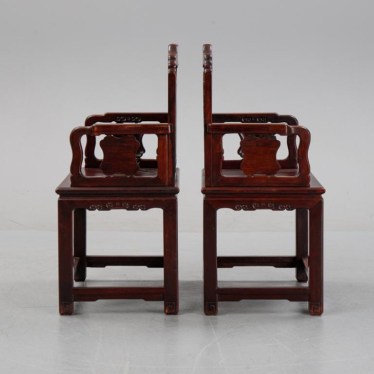 A pair of Chinese hardwood armchairs, presumably late Qing dynasty 19th century.