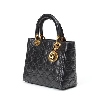 561. A black quilt leather handbag by Christian Dior.