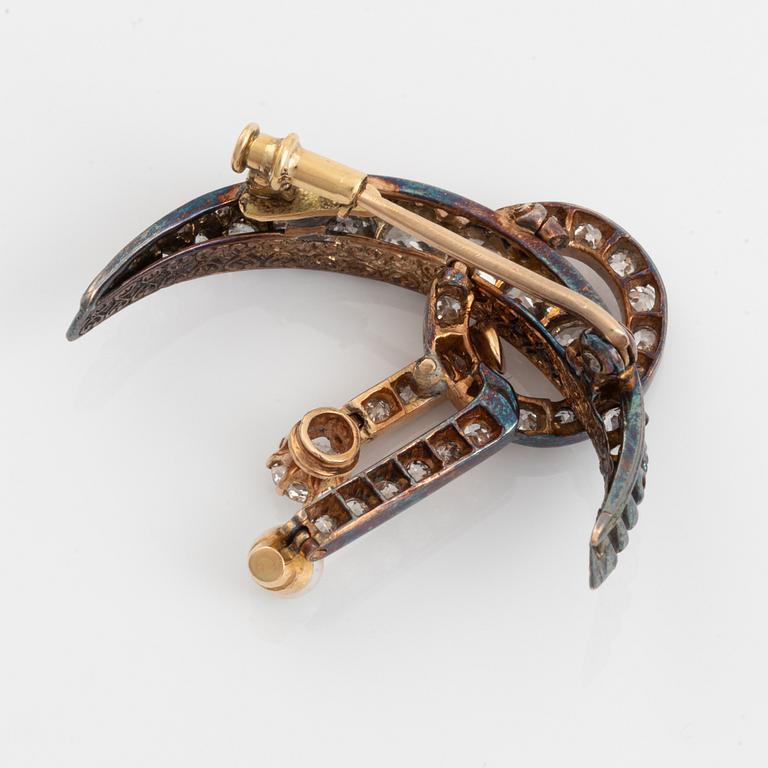 A 14K gold brooch set with old-cut diamonds and a pearl.