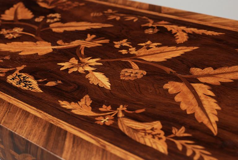 A Carl Malmsten mahogny table with inlays of different exotic woods, Sweden 1935.