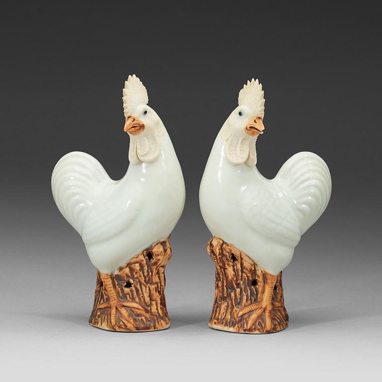 A pair of white and brown glazed figures of roosters, late Qing dynasty,