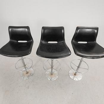 A set of three late 20th century metal and leather bar stools.