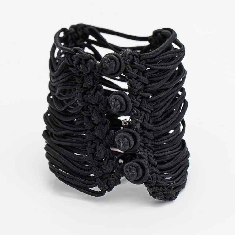 Ole Lynggaard, A satin like band bracelet with an 18K white gold and rose quartz "Sweet drops" pendant.