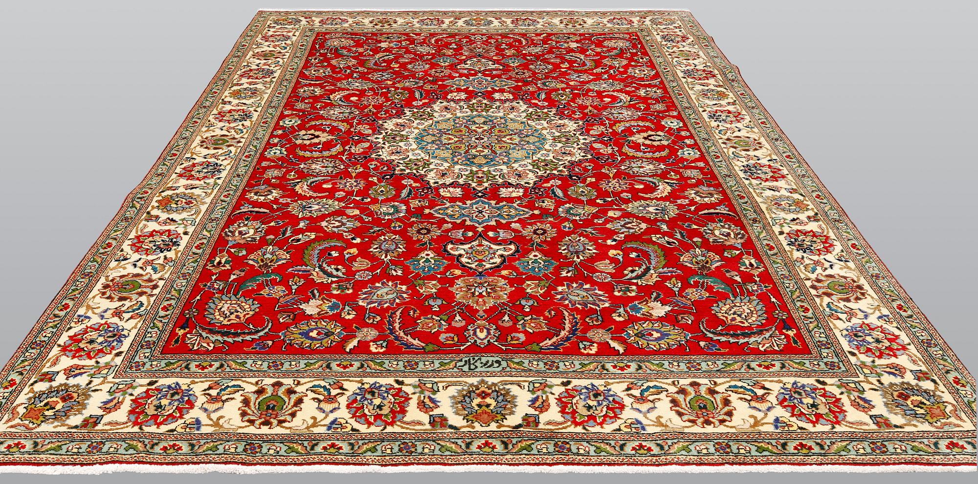 A signed Tabriz carpet, ca 336 x 223 cm.