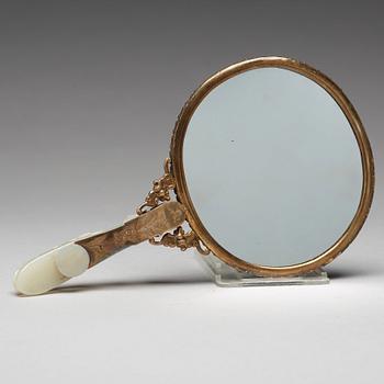 A Chinese metal mirror with a large carved nephrite placque and hook, early 20th Century.