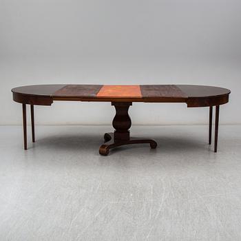 a mid 1800's mahogany dining table with three leaves.