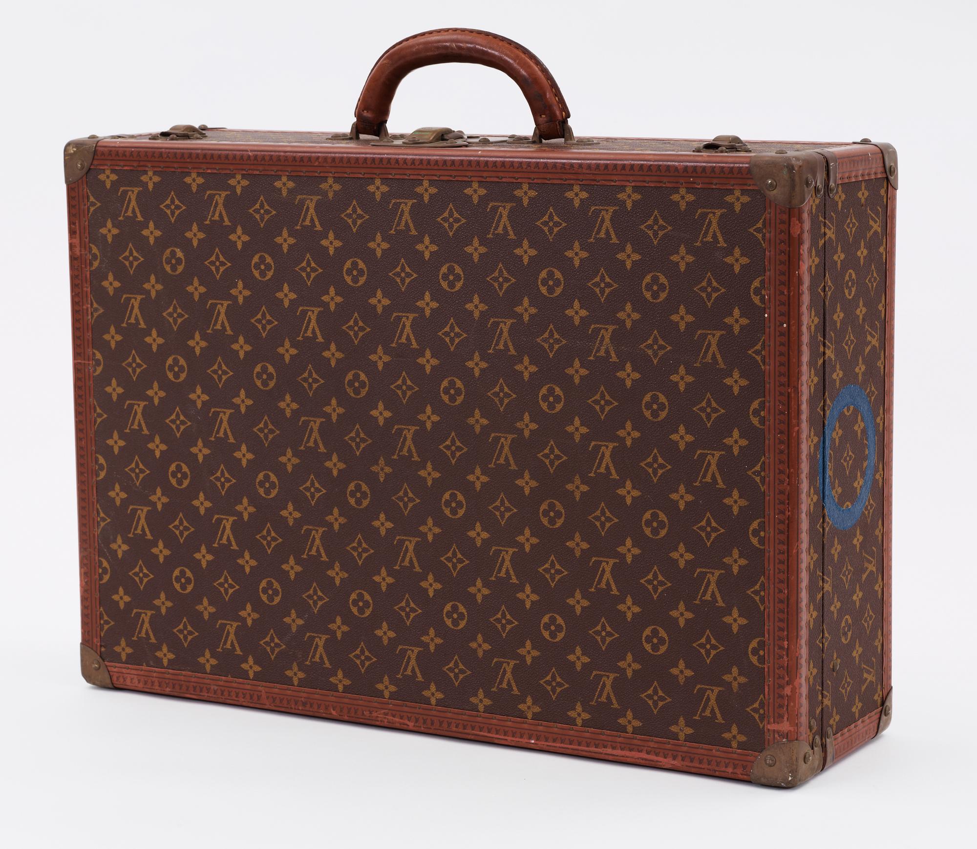 A monogram canvas suitcase by Louis Vuitton.