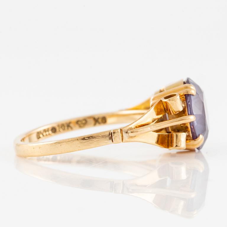 Ring 18K gold with a purple stone.