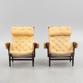 Bruno Mathsson, a pair of "Pernilla" armchair with ottoman, Dux, Sweden, second half of the 20th century.