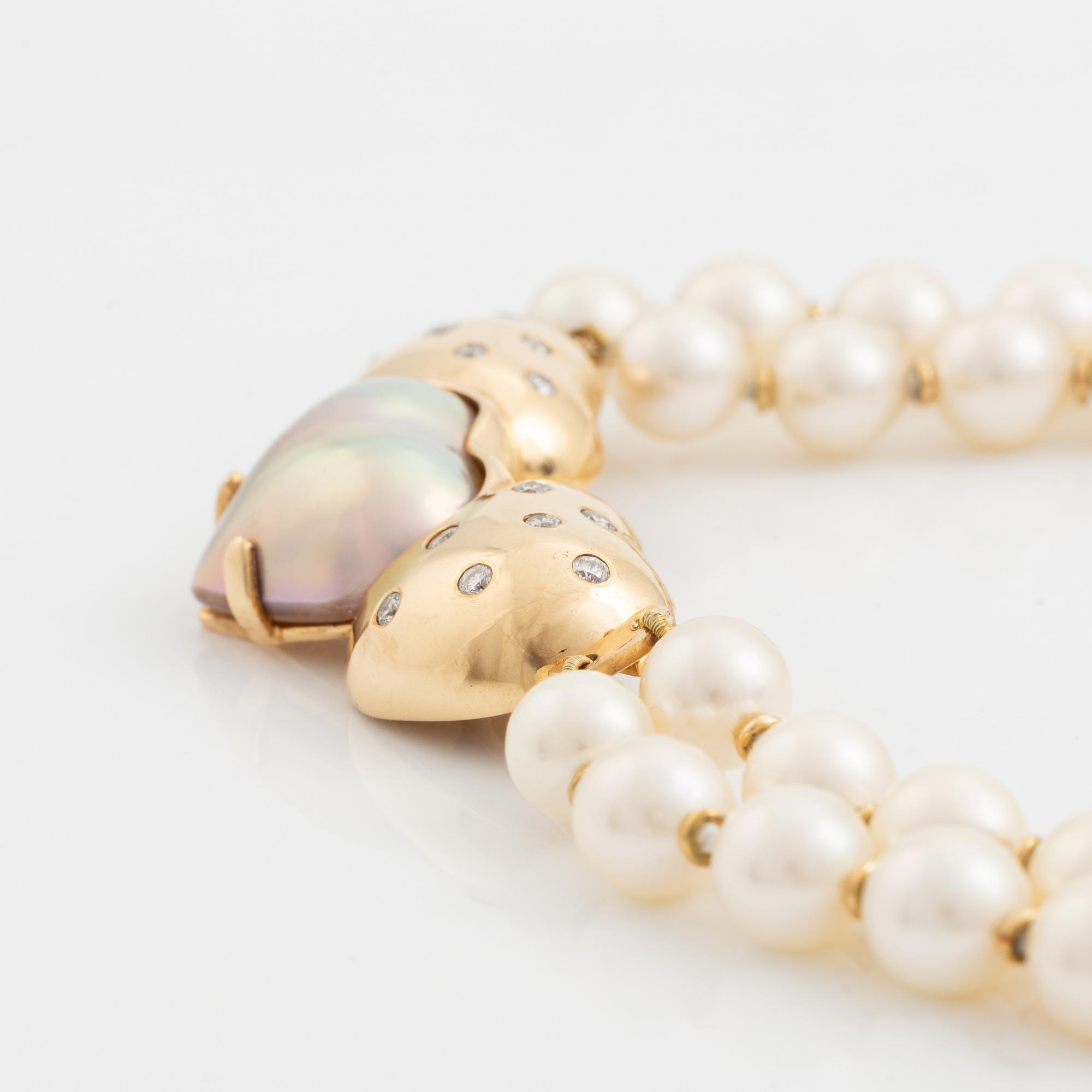 A two strand cultured pearl necklace with an 18K gold clasp with a half-pearl and round brilliant-cut diamonds.