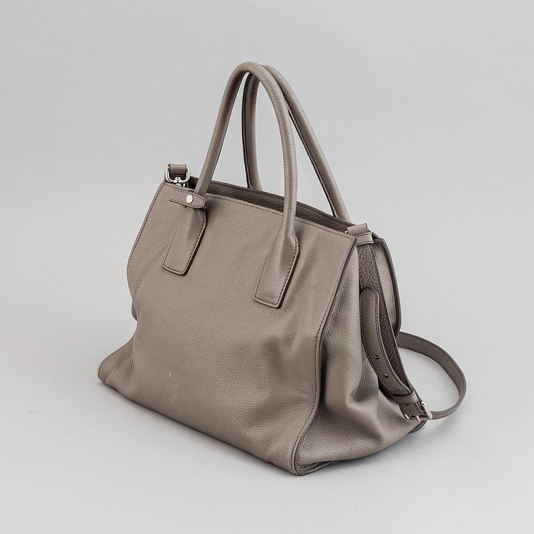 Prada, a leather handbag.