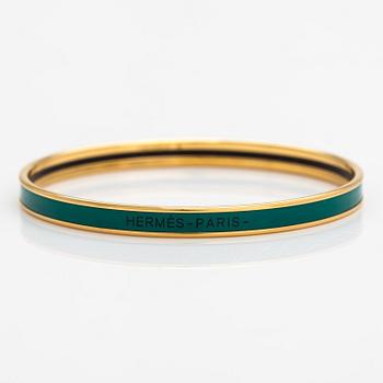 Hermès, a bracelet made of gold coloured metal and green enamel. Marked Hermès Paris, Made in France.