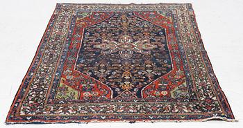 An oriental, semi-antique rug, c. 195 x 130 cm.