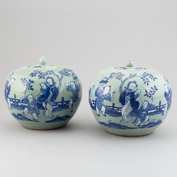 A pair of Chinese celadon glazed and blue and white jars with covers, 20th century.