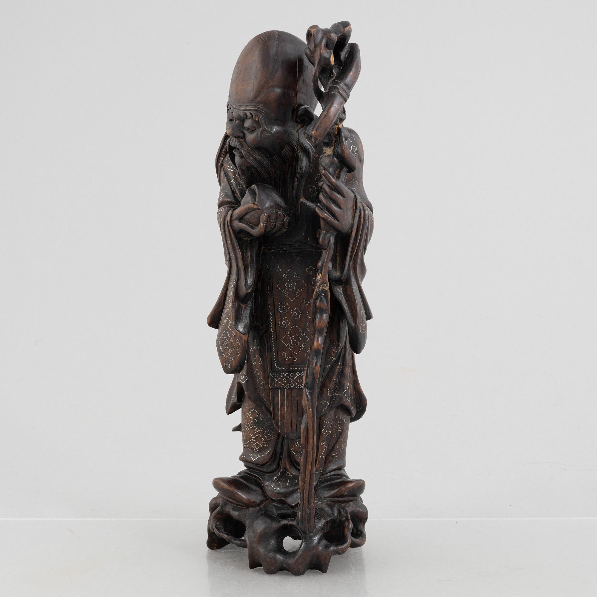 A Chinese wooden figure of 'Shoulao' with silver inlays, 20th century.