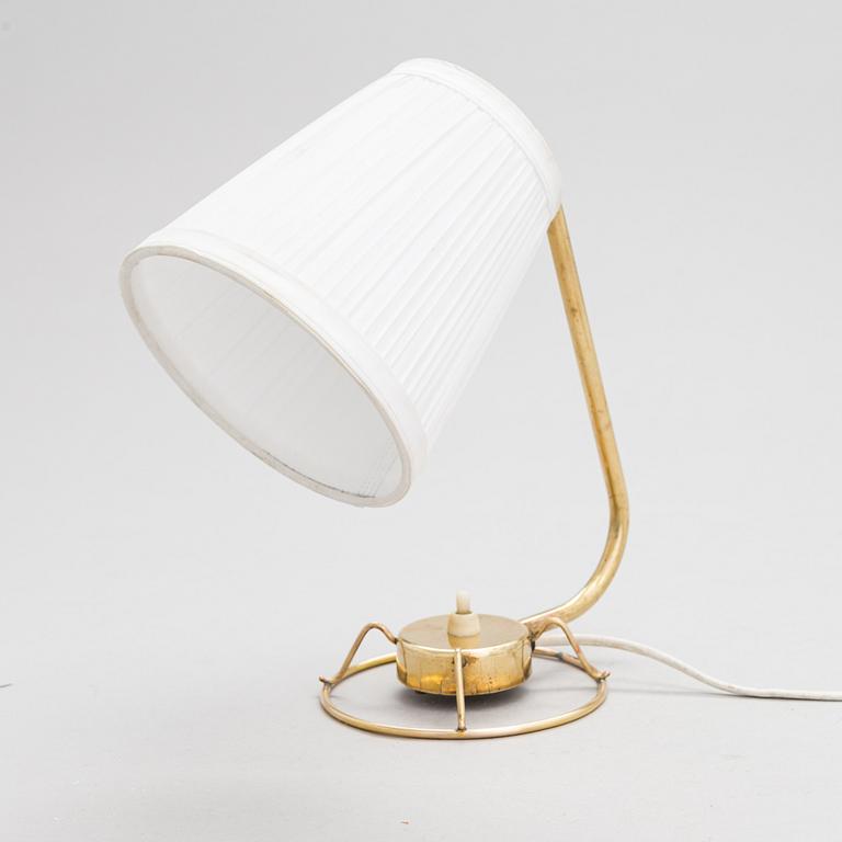 A mid-20th-century table lamp
/wall light for Idman.