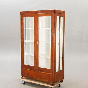An early 1900s walnut display cabinet.