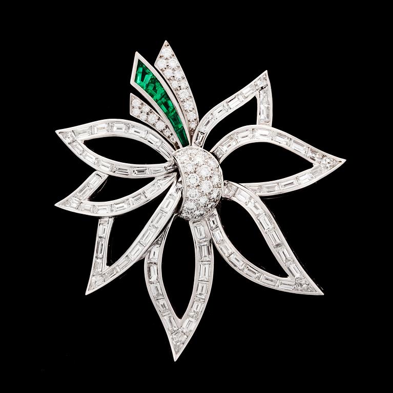 A brilliant cut diamond, tot. app 9 cts, and emerald brooch, 1970's.