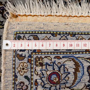 A semi-antique silk Keshan carpet, c. 350 x 248 cm.