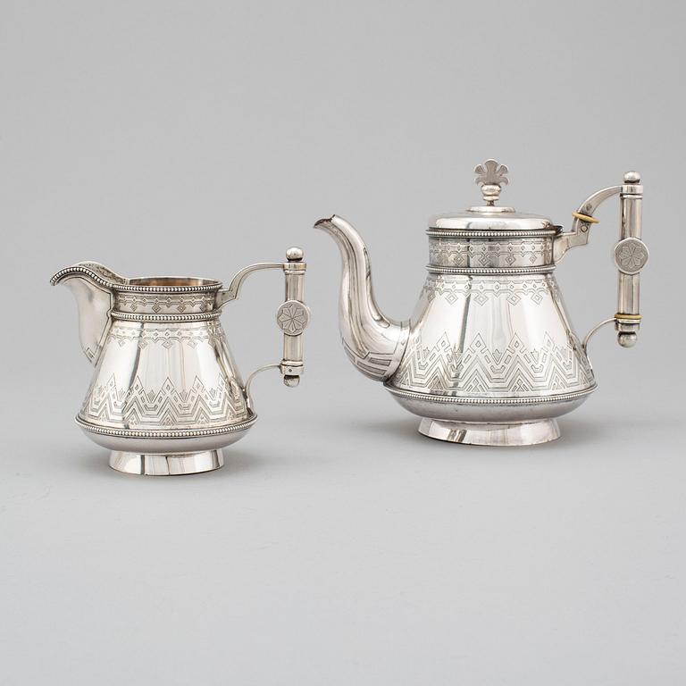 A Russian 19th century parcel-gilt silver tea pot and cream jug, mark possbly of Alexander Lokin, St. Petersburg 1893.