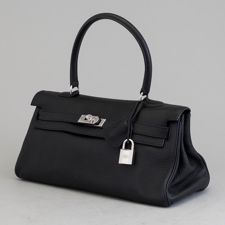 A black togo "JPG Shoulder Kelly 42" by Hermès 2009.