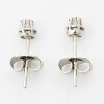 A pair of 18K white gold earrings with round brilliant-cut diamonds.
