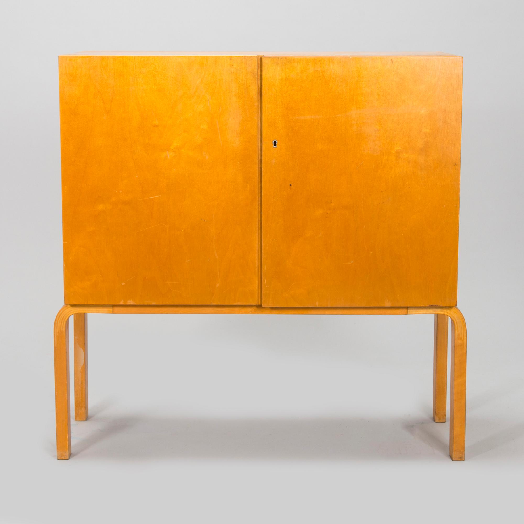Alvar Aalto, mid-20th century '810' cabinet and a 
'69'chair Oy Huonekalu- ja Rakennustyötehdas Ab.