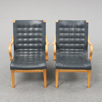 A second half of the 20th Century pair of 'Mina' armchairis by Bruno Mathsson for Mathsson International.
