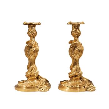 1255. A pair of Louis XV 18th century gilt bronze candlesticks after the model by Juste-Aurèle Meissonnier.